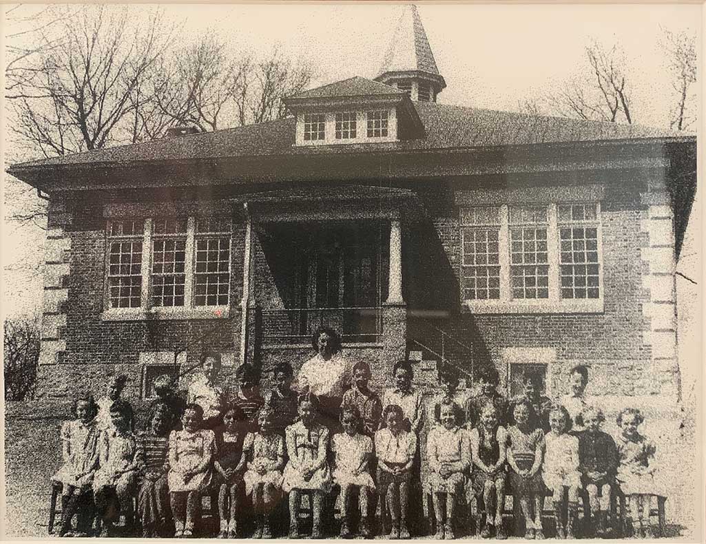 Two rows of young children and their teacher in front of Port Kennedy School